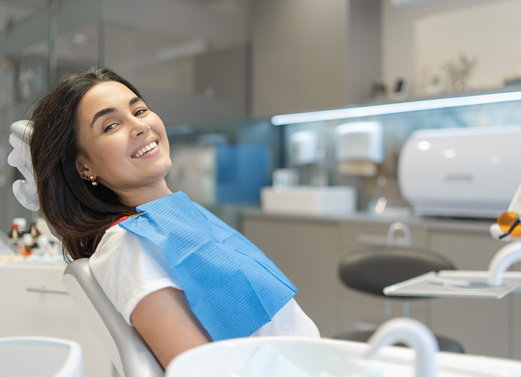 Smiling woman leaning back in the orthodontic treatment chair