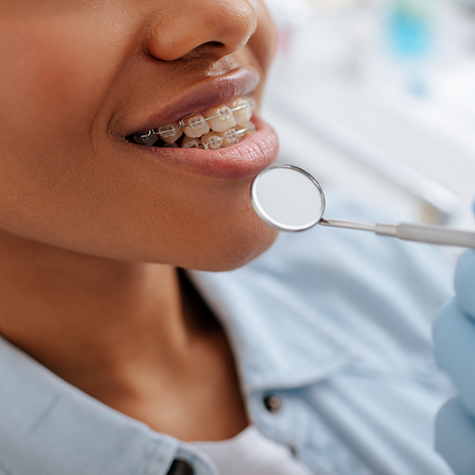 Person with braces receiving a dental exam