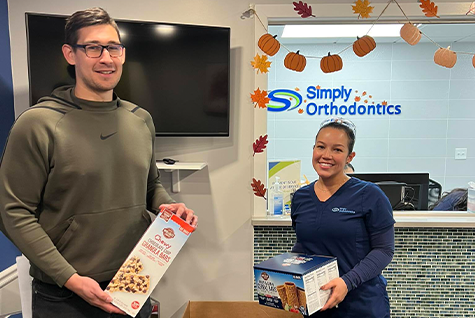 Simply Orthodontics team with donated food items