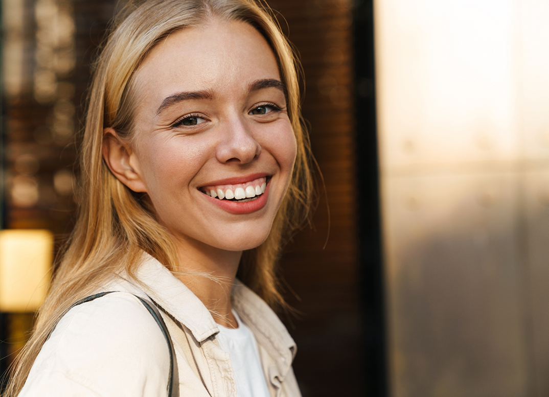 Blonde woman smiling after dentofacial orthopedics in New England