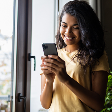 Young woman smiling at her phone