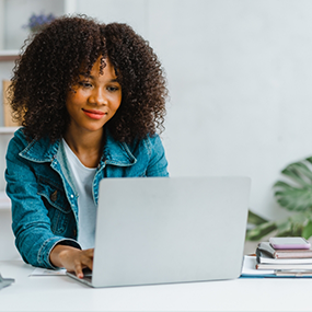 Woman sitting a desk with a laptop