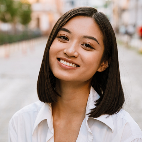 Smiling young woman with dark hair in a bob