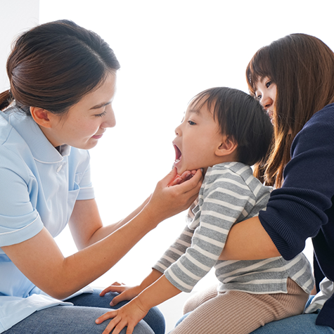 Pediatric orthodontist examining a baby's teeth