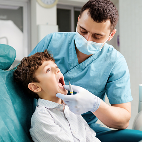 Orthodontist examining a child's teeth