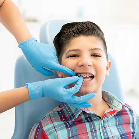 Young boy having braces placed on his teeth