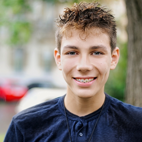 Smiling teenage boy with traditional braces