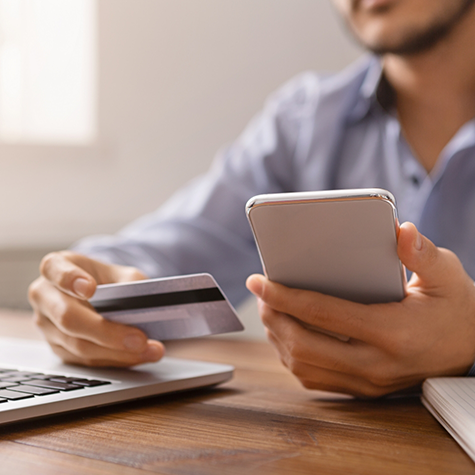 Person entering their credit card information onto a computer